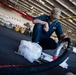 Sailor Monitors Lube Transfer in the Hangar Bay of USS Carl Vinson (CVN 70)