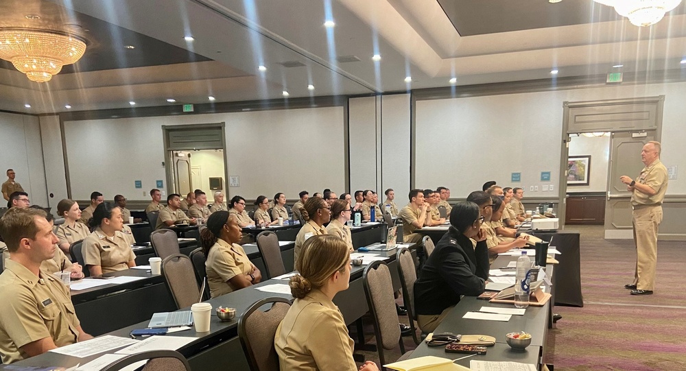 Rear Admiral Darin Via, Acting Surgeon General, speaks with new accession officers at Navy Medicine 101 course