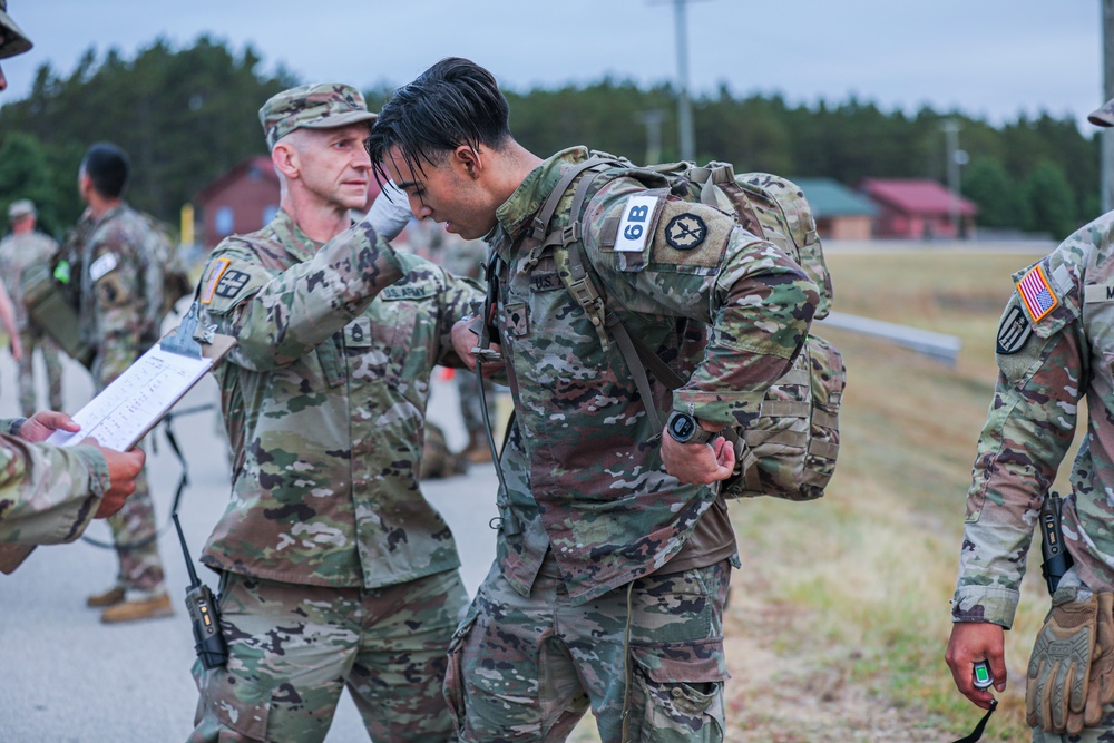 Spc. Stephan Mixter removes his rucksack after the 12 mile ruck