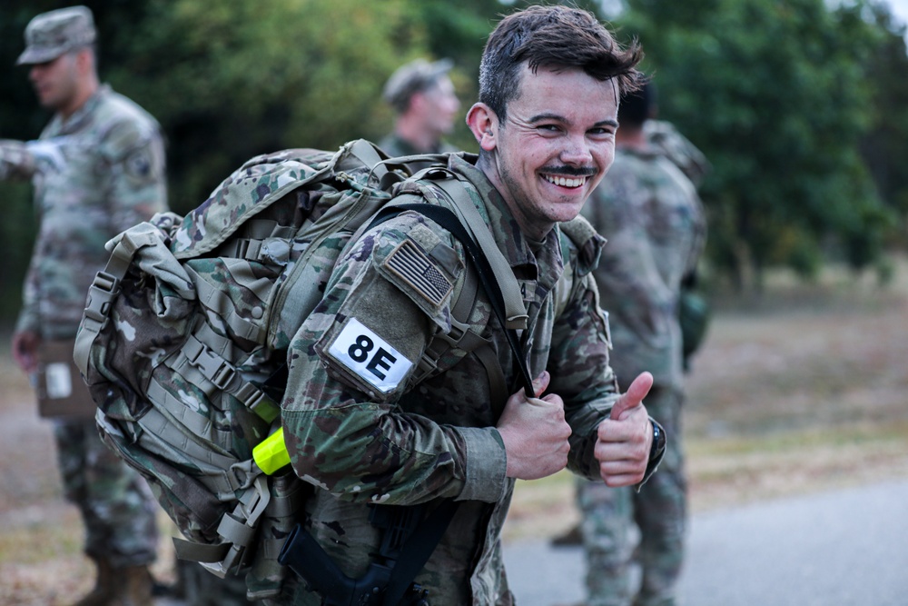 Spc. Trenton D. Tuberosa celebrates finishing the 12 mile ruck march