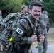 Spc. Trenton D. Tuberosa celebrates finishing the 12 mile ruck march