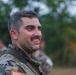 Spc. Anthony Caldarella celebrates finishing the 12 mile ruck march