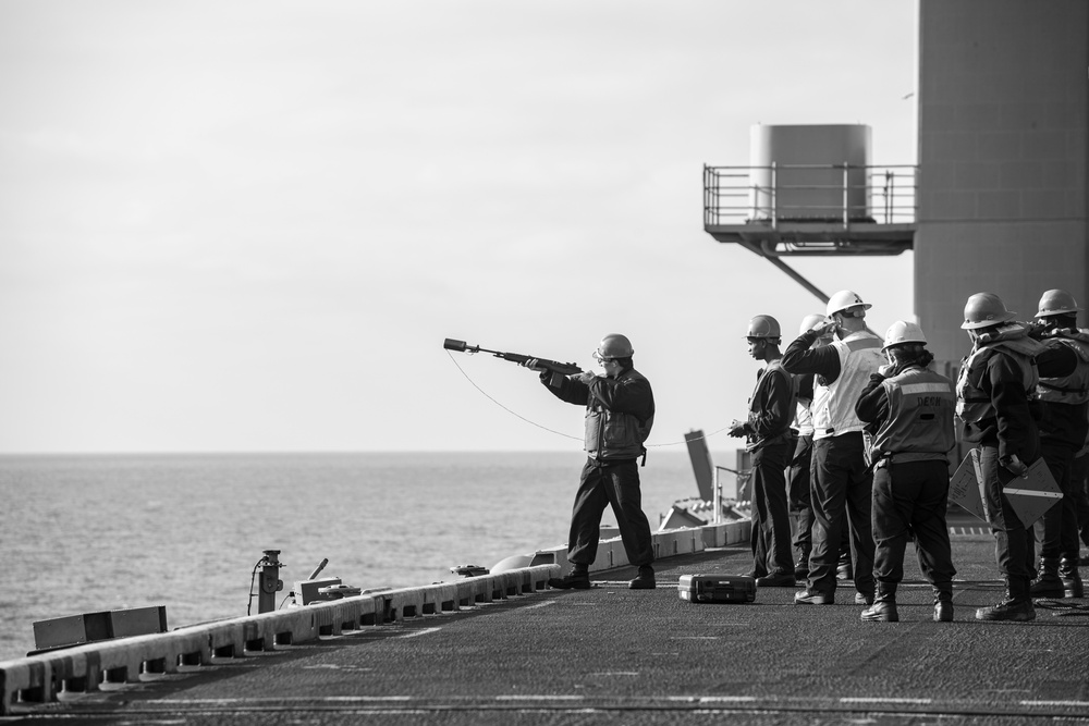 U.S. Navy Sailor Fires A Messenger Line