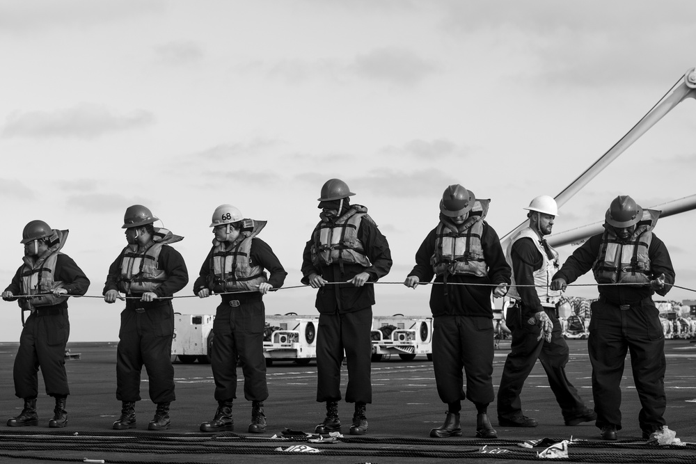 U.S. Navy Sailors Man A Phone And Distance Line