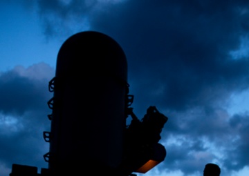 USCGC Munro Sailor Stands at Attention for Colors