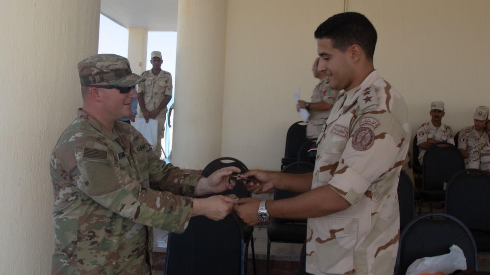 U.S. Army 1st Lt. Michael Needham, a unit public affairs representative for 1-155th Infantry, Task Force Reaper, trades patches with an Egyptian soldier, during exercise Bright Star 23