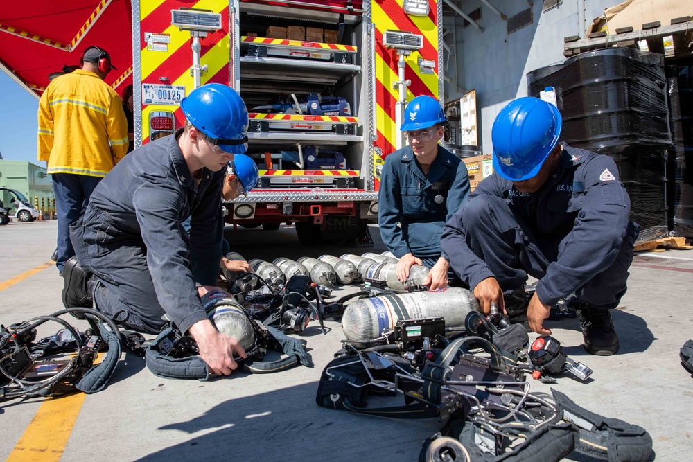 Makin Island Sailors and firefighters from Region Southwest Federal Fire Department participate in a simulated fire drill