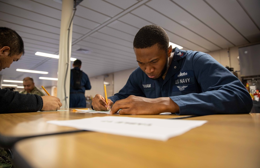 Sailors assigned to USS Makin Island participate in a Navy-wide advancement exam