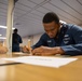 Sailors assigned to USS Makin Island participate in a Navy-wide advancement exam