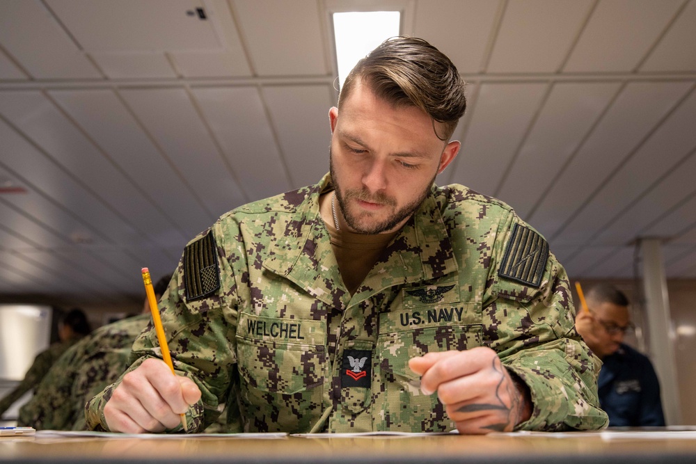 Sailors assigned to USS Makin Island participate in a Navy-wide advancement exam