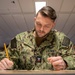 Sailors assigned to USS Makin Island participate in a Navy-wide advancement exam