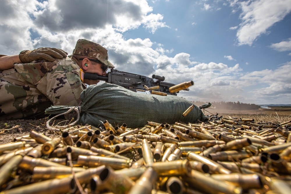Sgt. First Class Cutler Holland fires an M240 machine gun