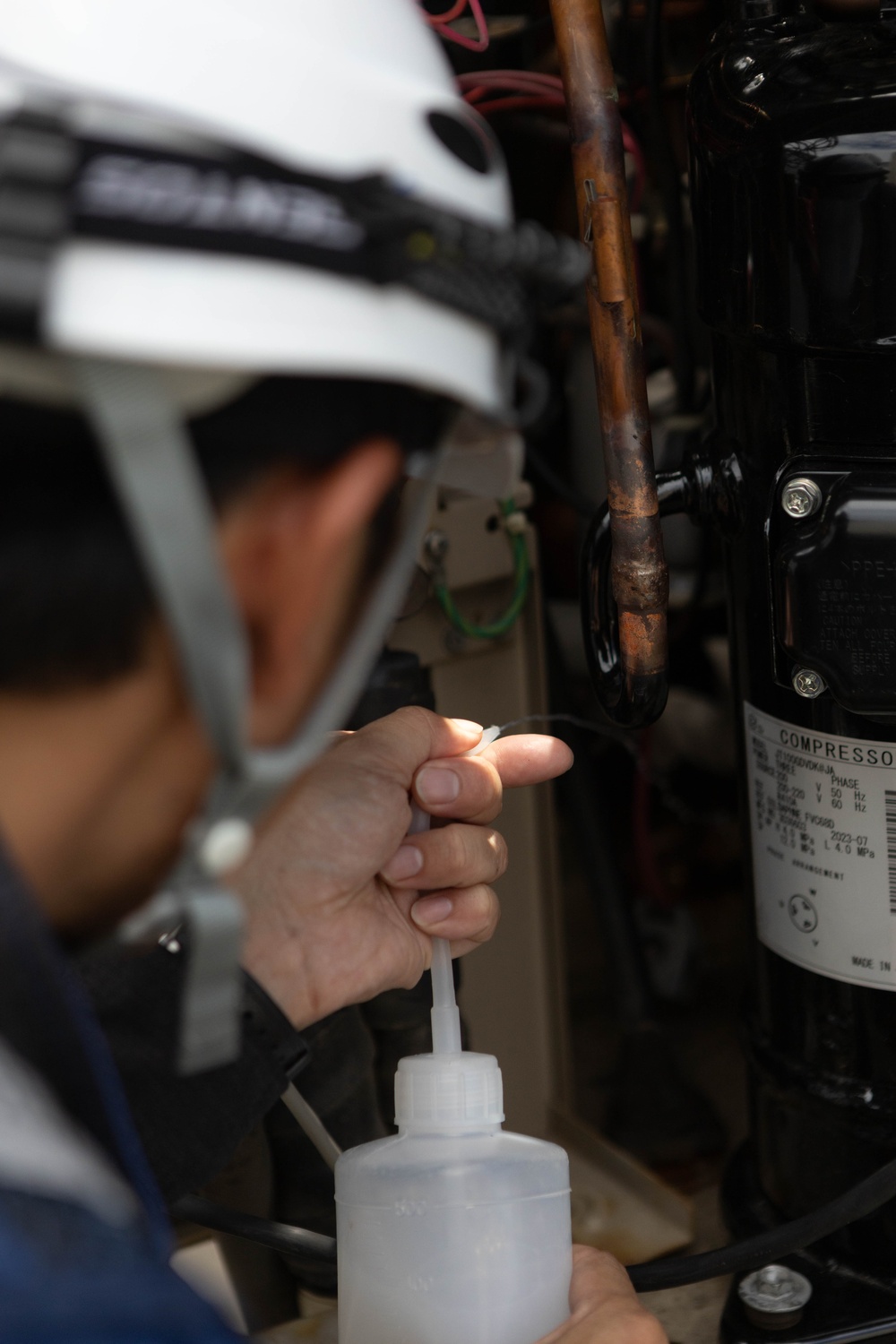 Keeping it Cool : Japanese Contractors on Marine Air Station Iwakuni repair air conditioning unit