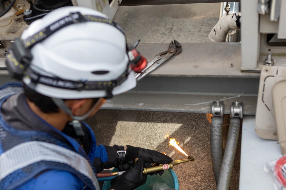 Keeping it Cool : Japanese Contractors on Marine Air Station Iwakuni repair air conditioning unit