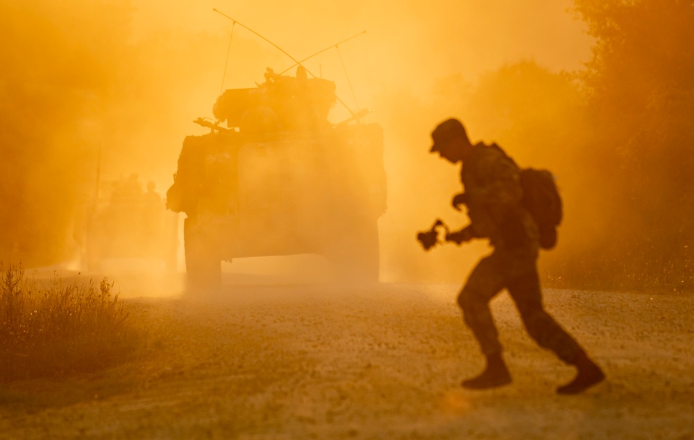 Opposition forces roll into a training village at Saber Junction 23