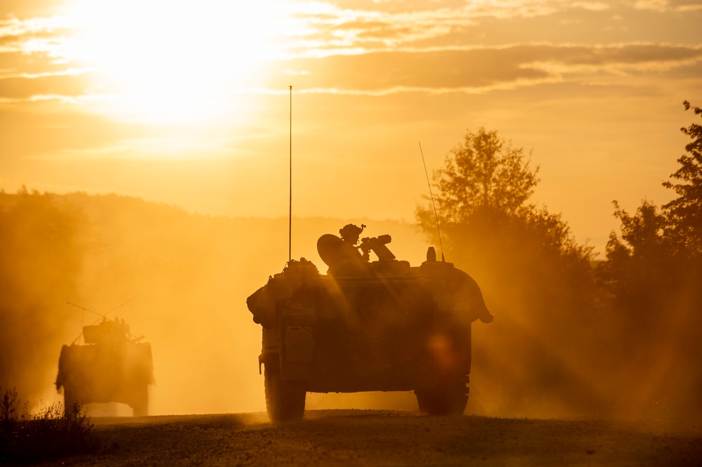 Opposition forces roll into a training village at Saber Junction 23