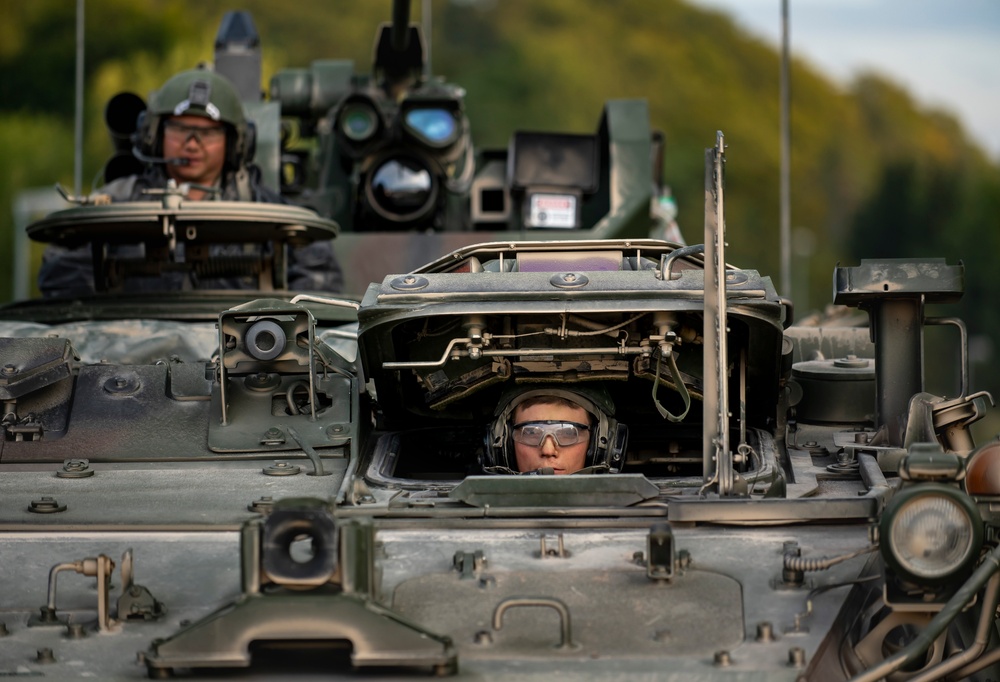 Opposition forces roll into a training village at Saber Junction 23