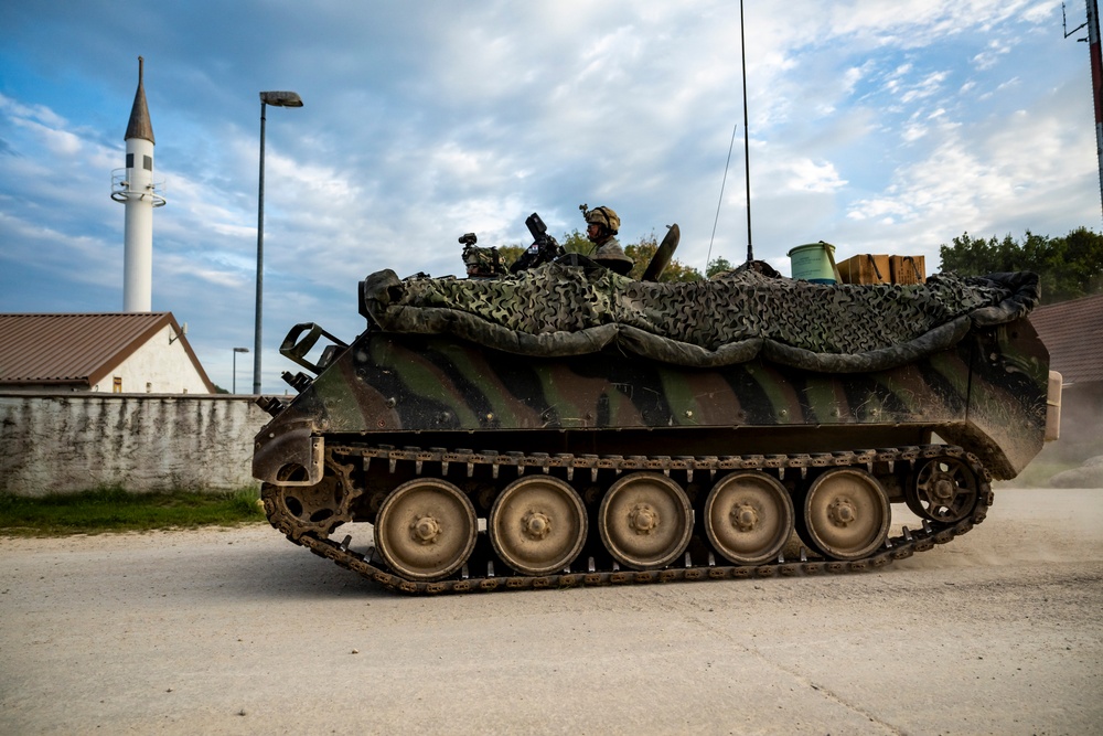 Opposition forces roll into a training village at Saber Junction 23