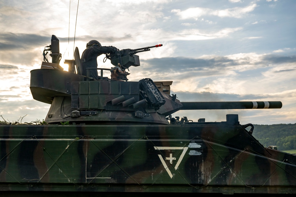 Opposition forces roll into a training village at Saber Junction 23