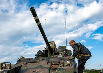 Opposition forces roll into a training village at Saber Junction 23