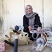 Waste picker Maha Dakkak sorts plastic and metal scrap in her home’s storage room.