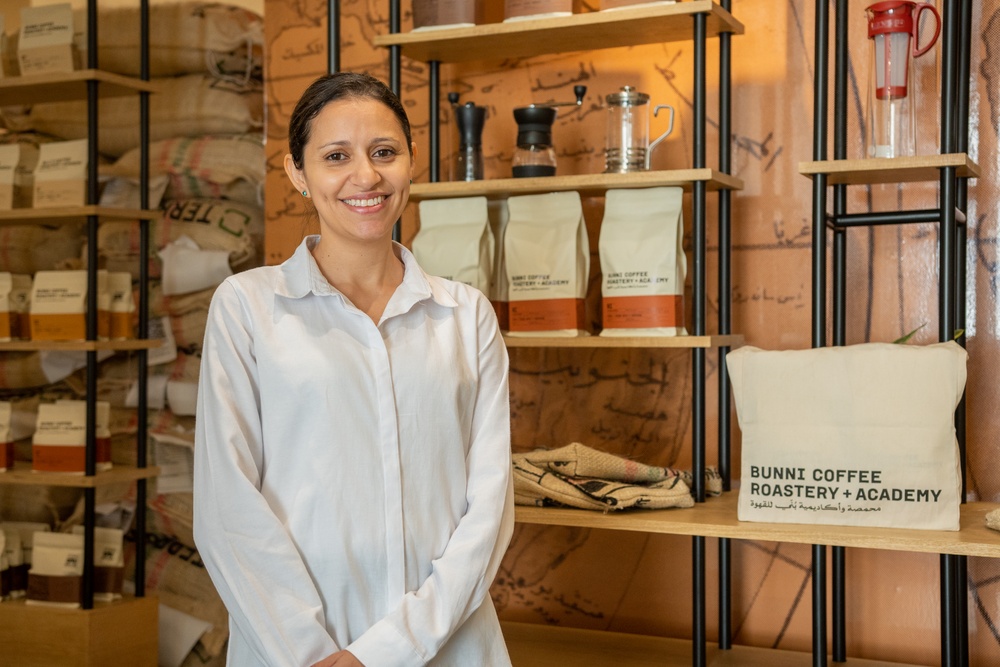 Shireen Muhaisen, owner of Bunni Coffee Roastery + Academy, showcases the shelves of coffee bags in her shop.