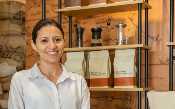 Shireen Muhaisen, owner of Bunni Coffee Roastery + Academy, showcases the shelves of coffee bags in her shop.