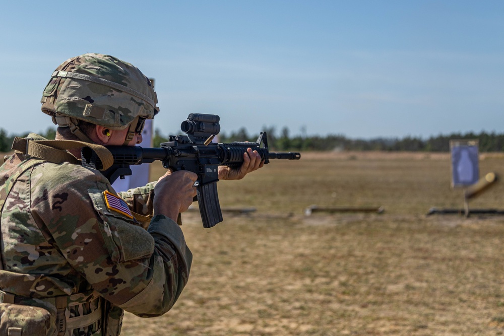 Spc. Peter Martin fires an M4 rifle during training at Fort
