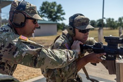 Sgt. Maj. Russell Moore gives shooting tips to Pfc. Vincent Wentorf [Image 4 of 7]