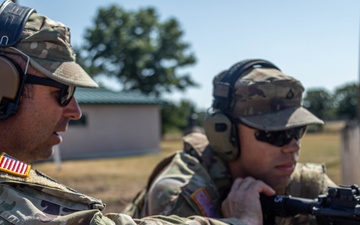 Sgt. Maj. Russell Moore gives shooting tips to Pfc. Vincent Wentorf