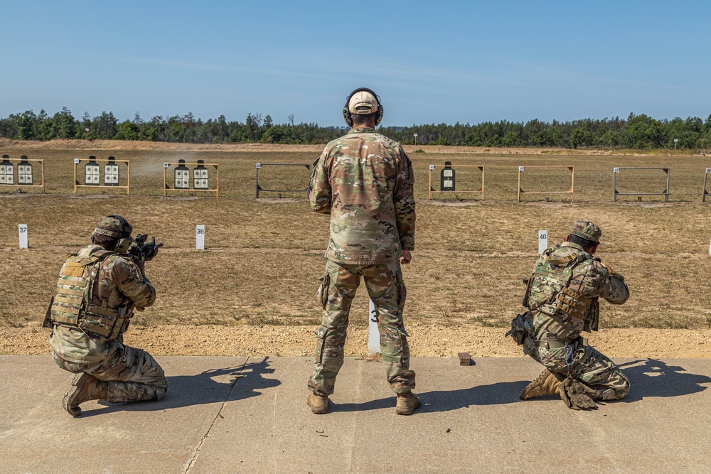 Warrant Officer Drew Wood leads two members of the 416th Theater Engineer Command squad through marksmanship drills