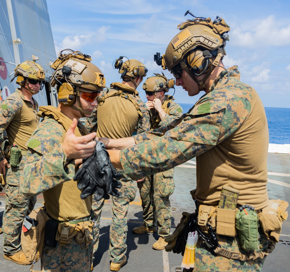 U.S. Marines Conduct Fast Rope Aboard The USS Greenbay