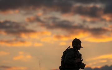 Soldiers stand watch at sunrise during Saber Junction 23