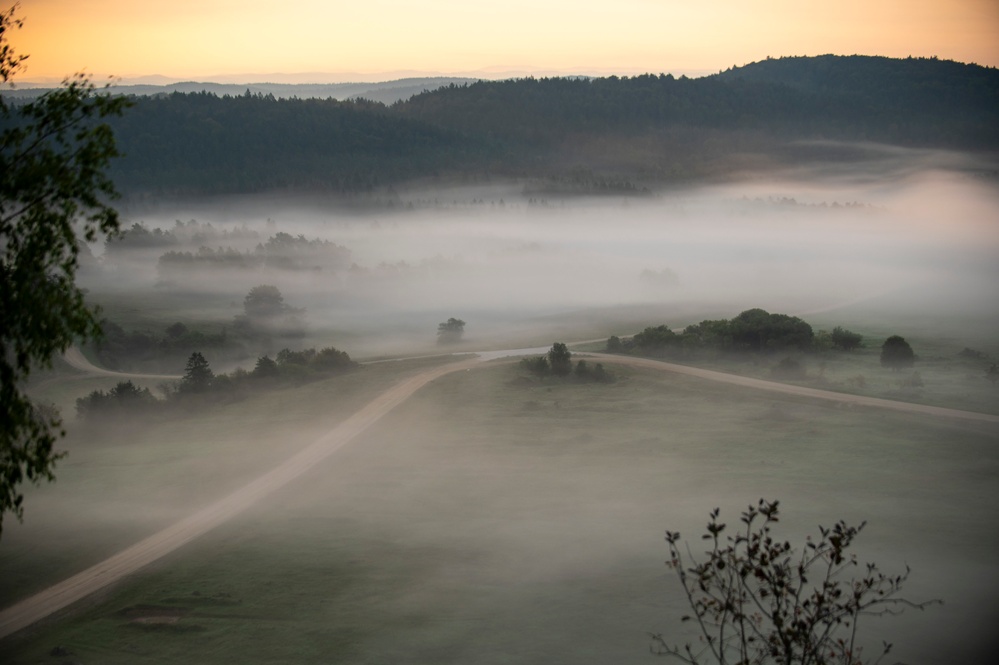 Soldiers stand watch at sunrise during Saber Junction 23