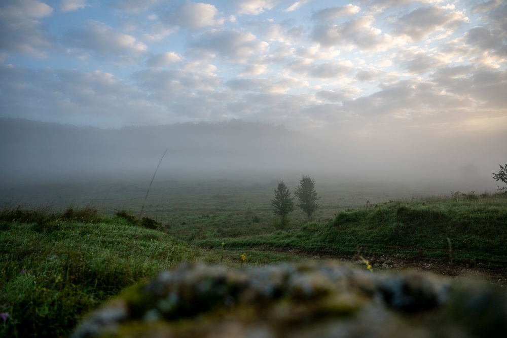 Soldiers stand watch at sunrise during Saber Junction 23