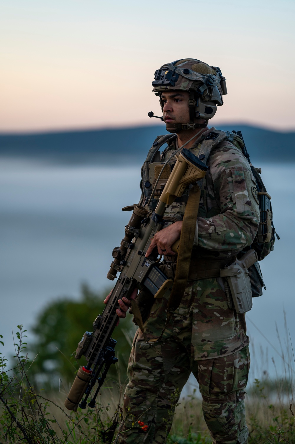 Soldiers stand watch at sunrise during Saber Junction 23