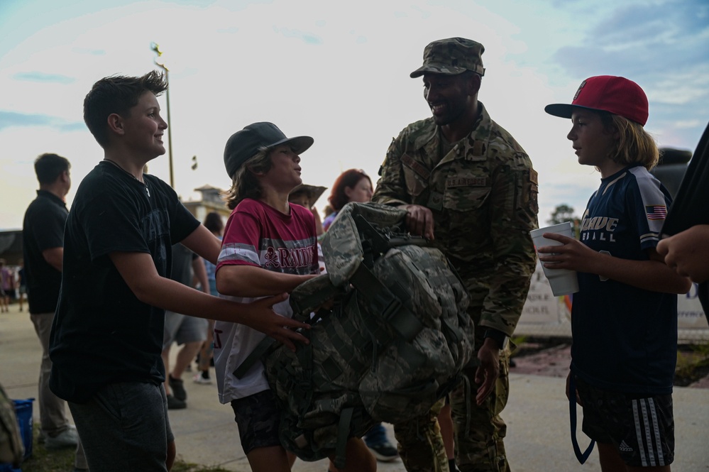 Airmen fly over and join FWB, Navarre Friday night football games