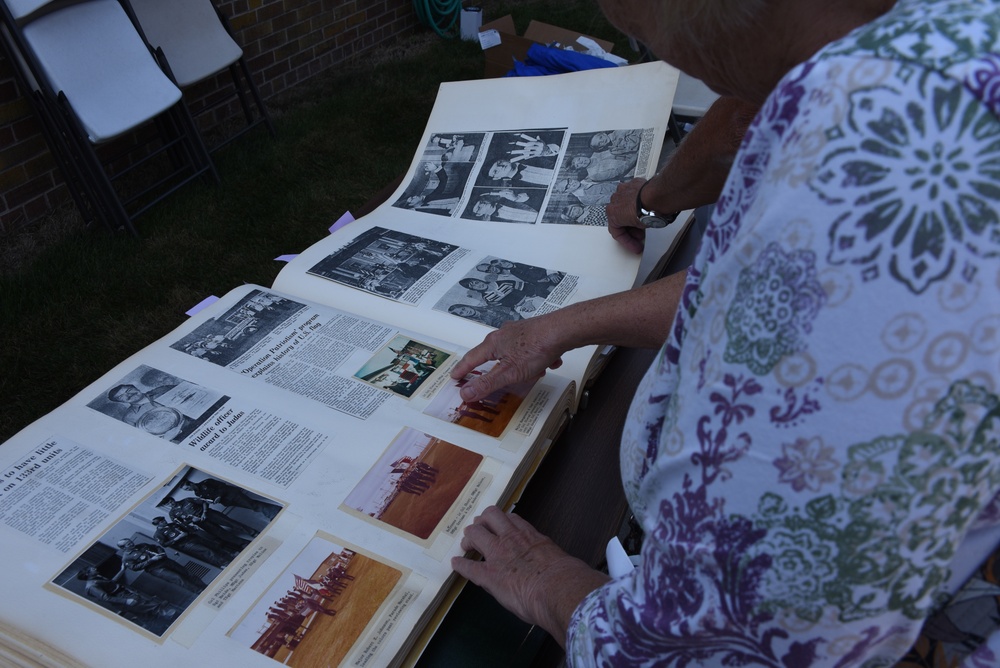 Visitors look at 133rd Test Squadron Scrapbook