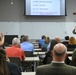 Commander, NSWC, briefs APEX Attendees