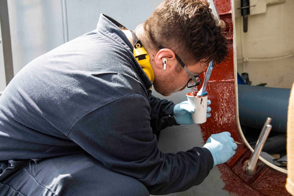 USS Ralph Johnson conducts paint preservation.