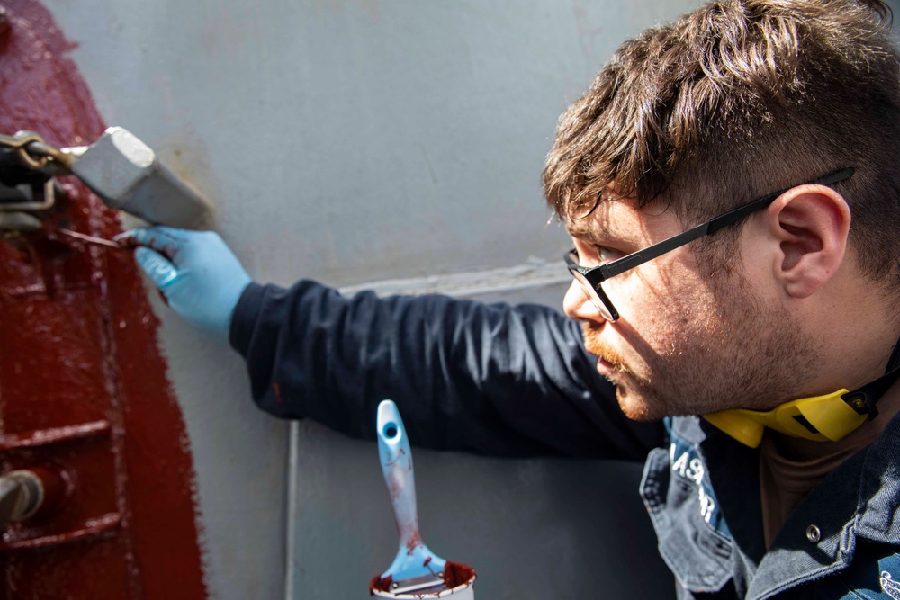 USS Ralph Johnson conducts paint preservation.