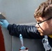 USS Ralph Johnson conducts paint preservation.