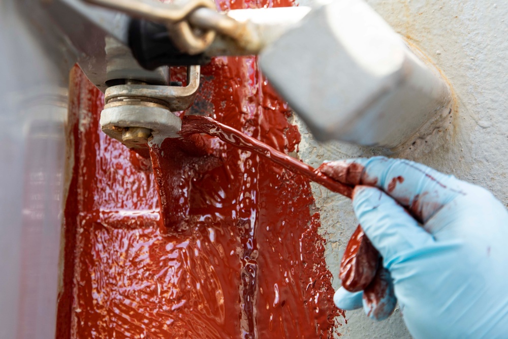 USS Ralph Johnson conducts paint preservation.