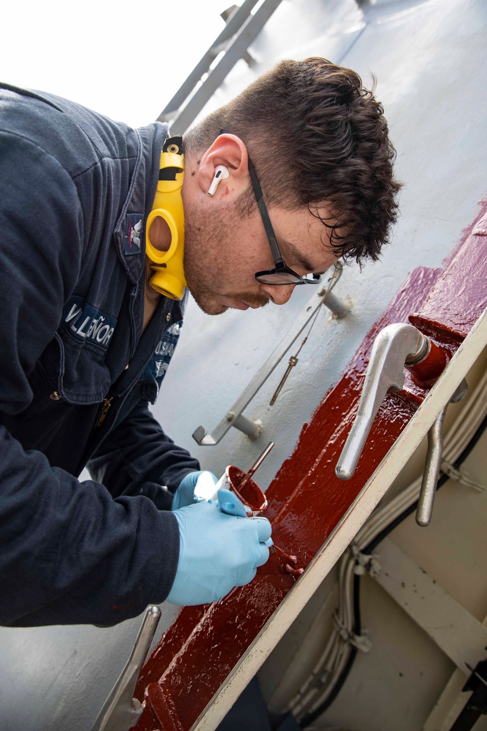 USS Ralph Johnson conducts paint preservation.