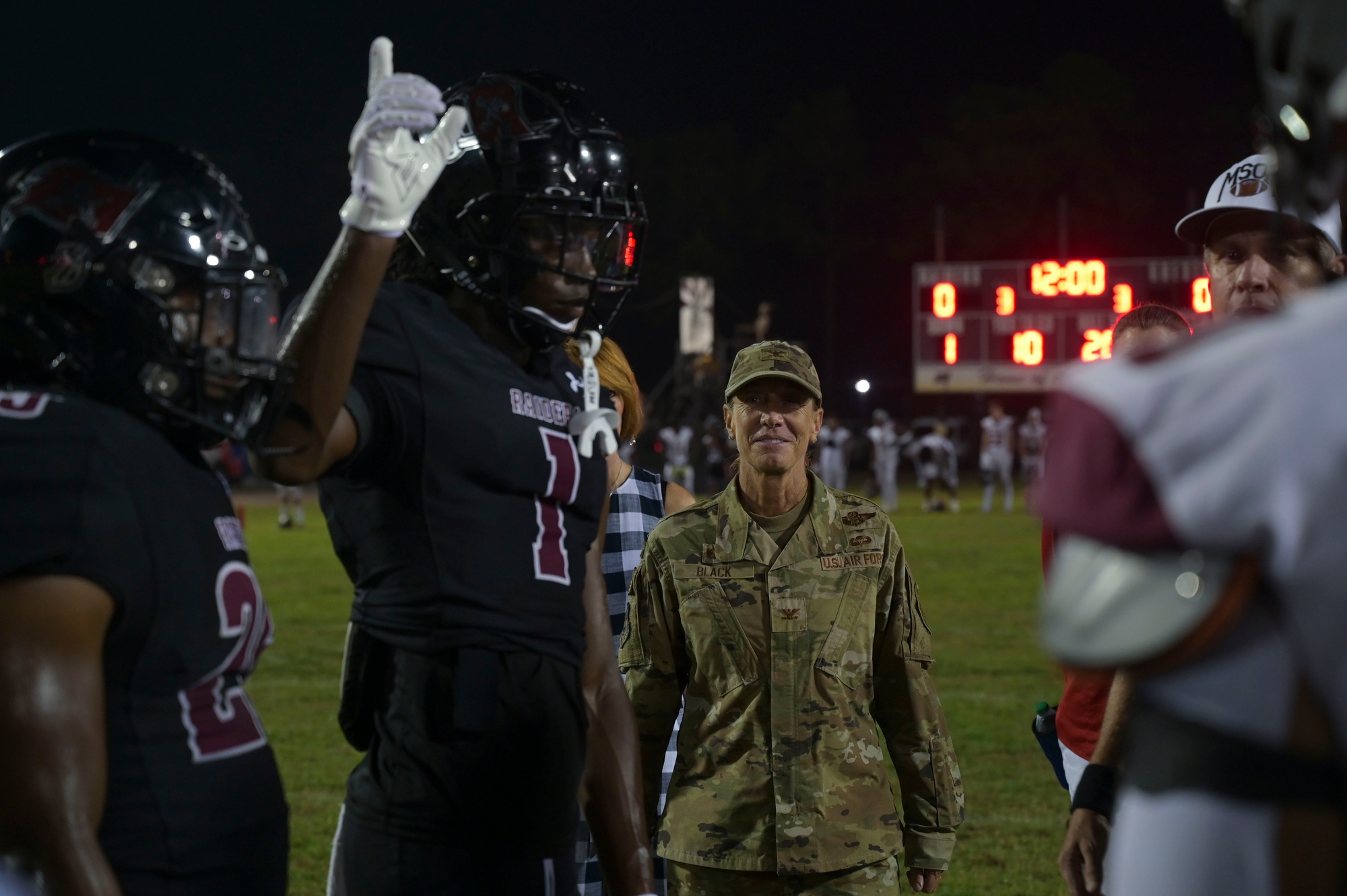 Airmen fly over and join FWB, Navarre Friday night football games