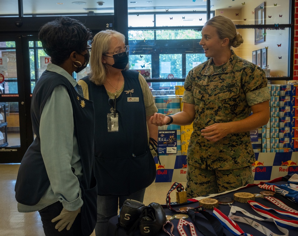 U.S. Marine Corps Capt. Riley Trejcek, an Olympic bobsledder, signs autographs at the commissary on Marine Corps Base Quantico