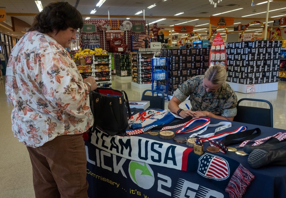 U.S. Marine Corps Capt. Riley Trejcek, an Olympic bobsledder, signs autographs at the commissary on Marine Corps Base Quantico