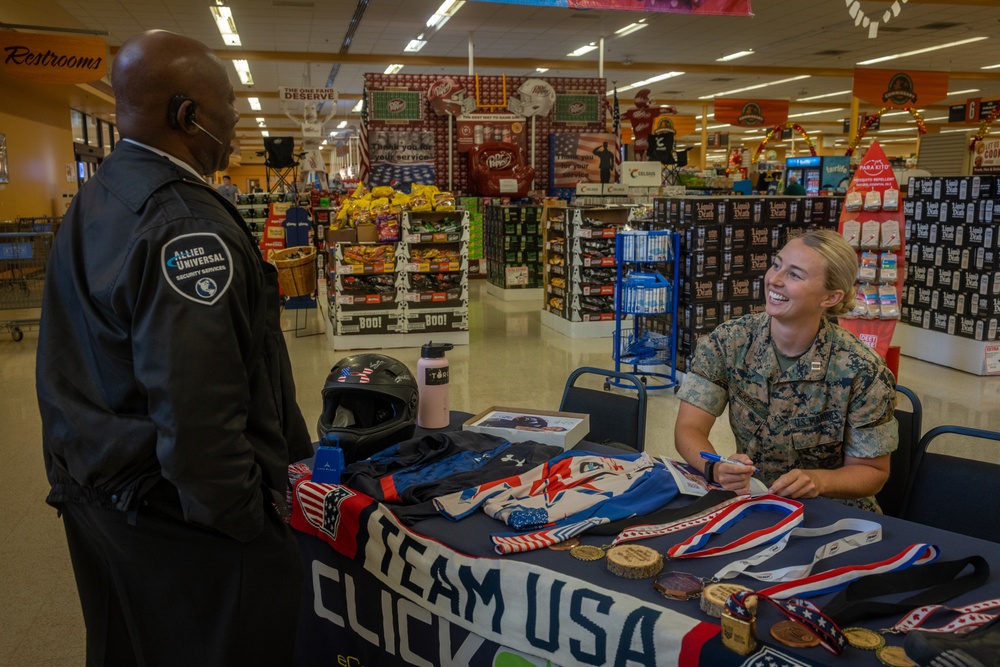 U.S. Marine Corps Capt. Riley Trejcek, an Olympic bobsledder, signs autographs at the commissary on Marine Corps Base Quantico