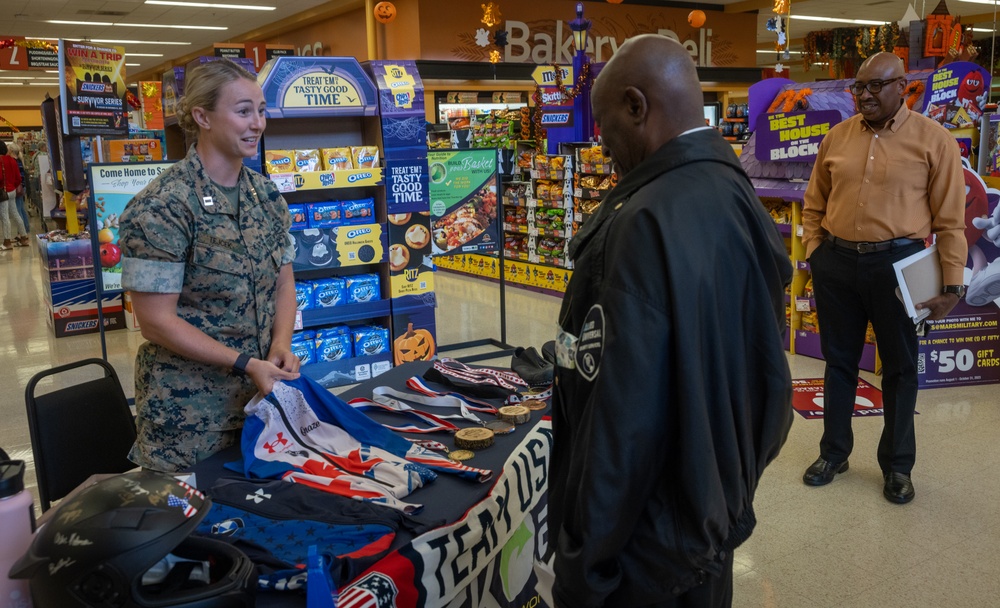 U.S. Marine Corps Capt. Riley Trejcek, an Olympic bobsledder, signs autographs at the commissary on Marine Corps Base Quantico