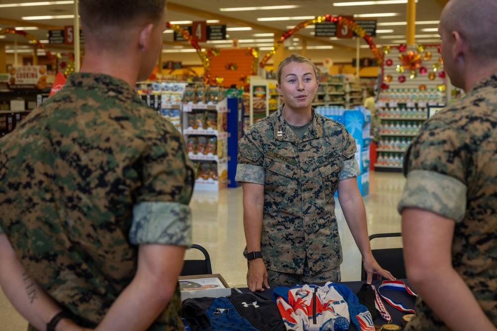 U.S. Marine Corps Capt. Riley Trejcek, an Olympic bobsledder, signs autographs at the commissary on Marine Corps Base Quantico